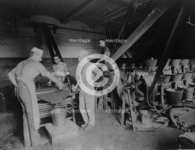 Workers grinding and processing the ink used to print paper money at the Bureau of Engrav..., c1890. Creator: Frances Benjamin Johnston.