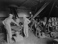 Workers grinding and processing the ink used to print paper money at the Bureau of Engrav..., c1890. Creator: Frances Benjamin Johnston