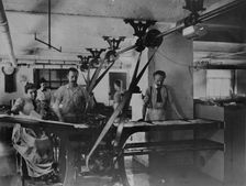 Workers in the postage stamp gumming and drying room in the Stamp Division..., ca 1895. Creator: Frances Benjamin Johnston