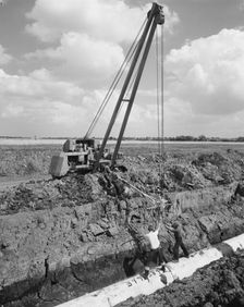 Workers laying a section of the Fens gas pipeline, Norfolk, 10/08/1967. Creator: John Laing plc
