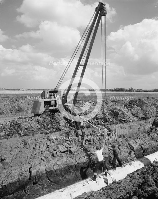 Workers laying a section of the Fens gas pipeline, Norfolk, 10/08/1967. Creator: John Laing plc.