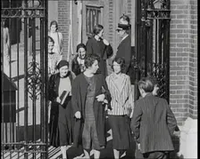 Workers Leaving Factory Through Factory Gates Which Are Closed After Them, 1932. Creator: British Pathe Ltd