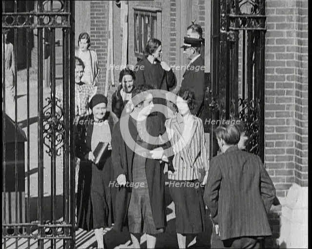 Workers Leaving Factory Through Factory Gates Which Are Closed After Them, 1932. Creator: British Pathe Ltd.