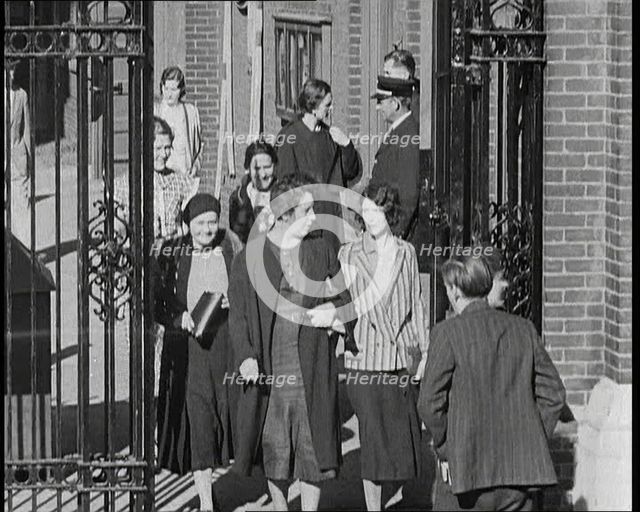 Workers Leaving Factory Through Factory Gates Which Are Closed After Them, 1932. Creator: British Pathe Ltd.