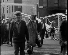 Workers Leaving Factory Through Factory Gates Which Are Closed After Them, 1932. Creator: British Pathe Ltd