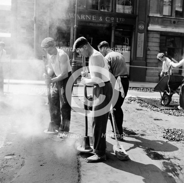 Workers repairing Queen Victoria Street, Westminster, London, 1955. Creator: Henry Grant.