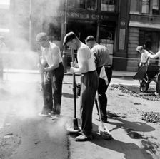 Workers repairing Queen Victoria Street, Westminster, London, 1955. Creator: Henry Grant