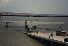 Working with a sea-plane at the Naval Air Base, Corpus Christi, Texas, 1942. Creator: Howard Hollem