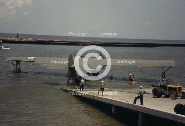 Working with a sea-plane at the Naval Air Base, Corpus Christi, Texas, 1942. Creator: Howard Hollem.
