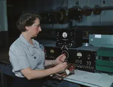 Working with the electric wiring at Douglas Aircraft Company, Long Beach, Calif., 1942. Creator: Alfred T Palmer
