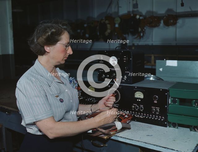 Working with the electric wiring at Douglas Aircraft Company, Long Beach, Calif., 1942. Creator: Alfred T Palmer.
