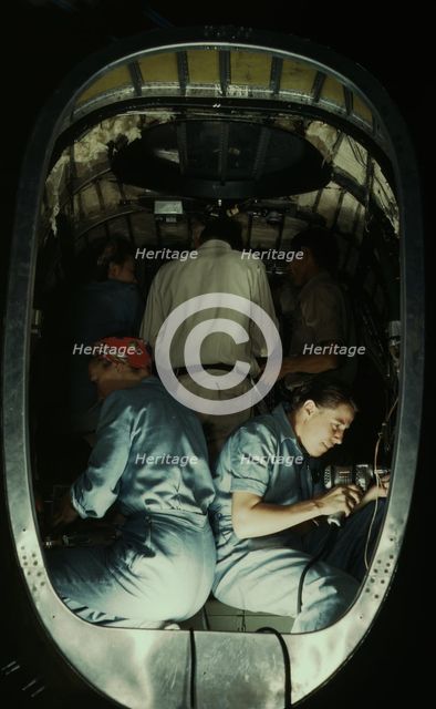 Working inside fuselage of a Liberator Bomber, Consolidated Aircraft Corp., Fort Worth, Texas, 1942. Creator: Howard Hollem.
