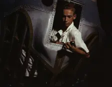 Working inside the nose of a PBY, Elmer J. Pace is learning the...Corus Christi, Texas, 1942. Creator: Howard Hollem