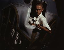Working inside the nose of a PBY, Elmer J. Pace is learning the...Corus Christi, Texas, 1942. Creator: Howard Hollem