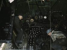 Working on the cab of a locomotive brought in for repair at the C & NW RR, Chicago, Ill., 1942. Creator: Jack Delano