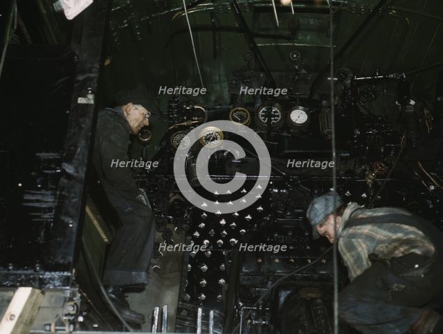 Working on the cab of a locomotive brought in for repair at the C & NW RR, Chicago, Ill., 1942. Creator: Jack Delano.