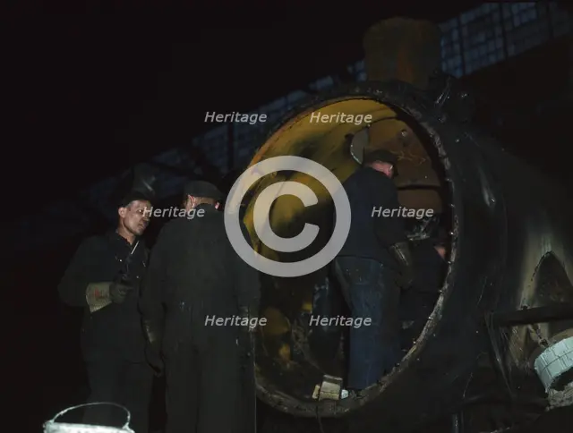 Working on the boiler of a locomotive at the 40th Street shops of the C & NW RR, Chicago, Ill., 1942 Creator: Jack Delano.