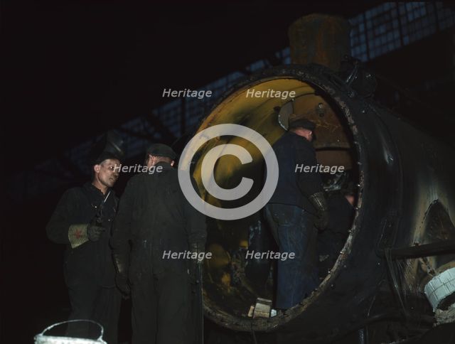 Working on the boiler of a locomotive at the 40th Street shops of the C & NW RR, Chicago, Ill., 1942 Creator: Jack Delano.