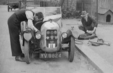 Working on the engine of E Martin's Austin Swallow at the North West London Motor Club Trial, 1929. Artist: Bill Brunell