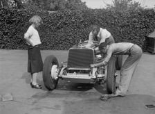 Working on the engine of Raymond Mays Vauxhall-Villiers, c1930s. Artist: Bill Brunell