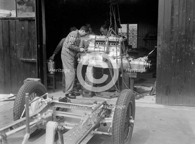 Working on the engine of Raymond Mays' Vauxhall-Villiers, c1930s. Artist: Bill Brunell.