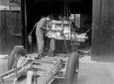 Working on the engine of Raymond Mays Vauxhall-Villiers, c1930s. Artist: Bill Brunell