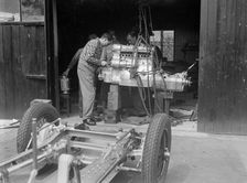 Working on the engine of Raymond Mays Vauxhall-Villiers, c1930s. Artist: Bill Brunell