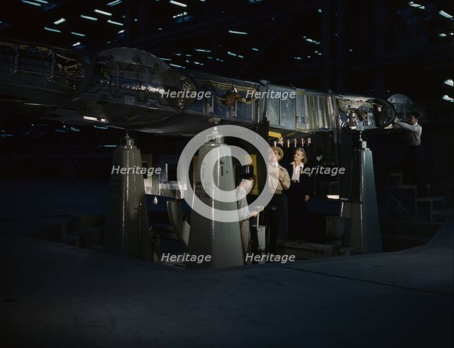 Working on the wing center section at the Consolidated Aircraft Corp..., Fort Worth, Texas, 1942. Creator: Howard Hollem.