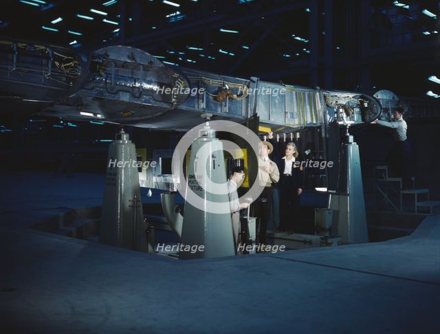 Working on wing of Consolidated Liberator..., Consolidated Aircraft Corp., Fort Worth, Texas, 1942. Creator: Howard Hollem.