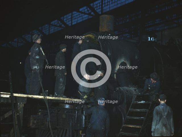 Working on a locomotive at the 40th Street shop of the C & NW RR, Chicago, Ill., 1942. Creator: Jack Delano.