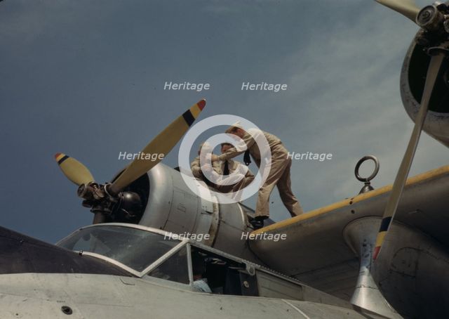 Working on a plane at the Naval Air Base, Corpus Christi, Texas, 1942. Creator: Howard Hollem.