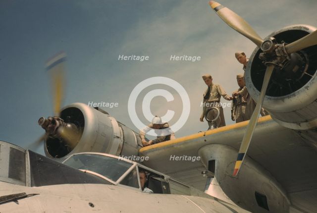 Working on a plane at the Naval Air Base, Corpus Christi, Texas, 1942. Creator: Howard Hollem.