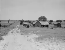 Worn-out land and abandoned cabins near Newport, Oklahoma, 1937. Creator: Dorothea Lange