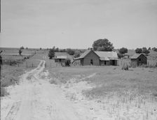 Worn-out land and abandoned cabins near Newport, Oklahoma, 1937. Creator: Dorothea Lange