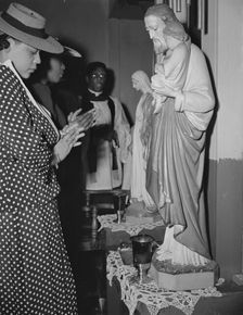 Worshipper before the altar of the St. Martin's Spiritual Church, Washington, D.C., 1942. Creator: Gordon Parks