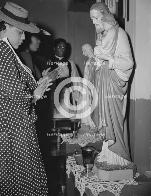 Worshipper before the altar of the St. Martin's Spiritual Church, Washington, D.C., 1942. Creator: Gordon Parks.