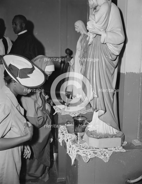 Worshippers before the altar in the St. Martin's Spiritual Church, Washington, D.C., 1942. Creator: Gordon Parks.