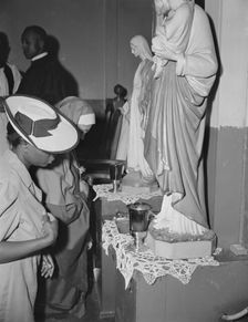 Worshippers before the altar in the St. Martin's Spiritual Church, Washington, D.C., 1942. Creator: Gordon Parks
