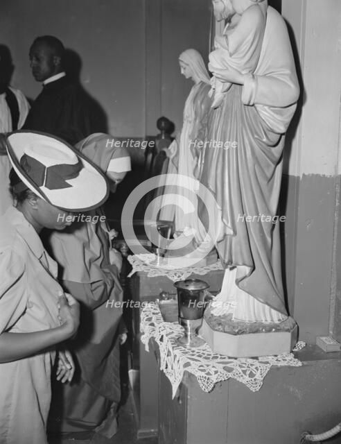 Worshippers before the altar in the St. Martin's Spiritual Church, Washington, D.C., 1942. Creator: Gordon Parks.