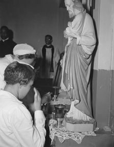 Worshippers before the altar in the St. Martin's Spiritual Church, Washington, D.C., 1942. Creator: Gordon Parks