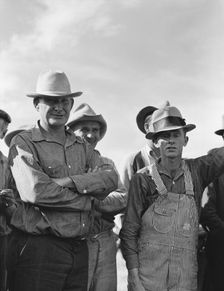 Watching ball game, Shafter camp for migrants, California, 1938. Creator: Dorothea Lange