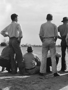 Watching ball game, Shafter camp for migrants, California, 1939. Creator: Dorothea Lange