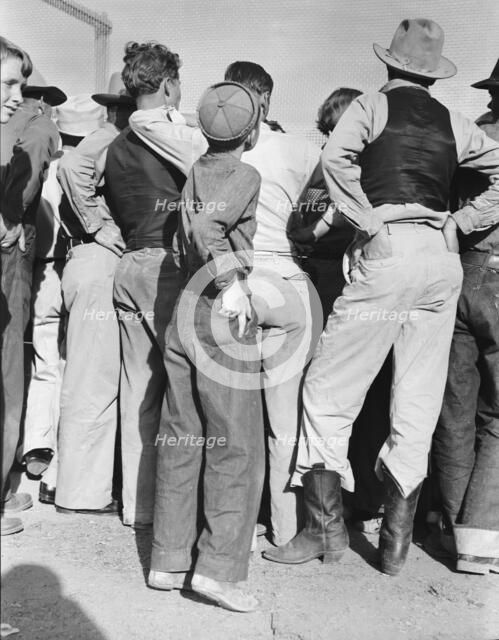 Watching ball game, Shafter migrant camp, California, 1938. Creator: Dorothea Lange.