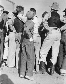 Watching ball game, Shafter migrant camp, California, 1938. Creator: Dorothea Lange