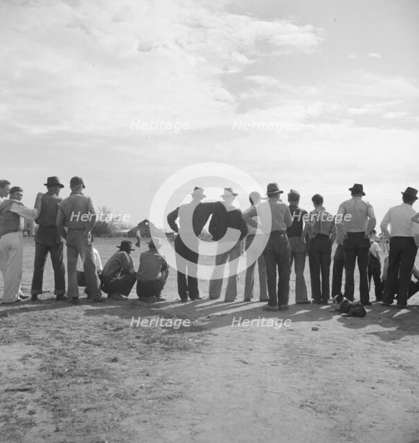 Watching ball game, Shafter migrant camp, California, 1938. Creator: Dorothea Lange.