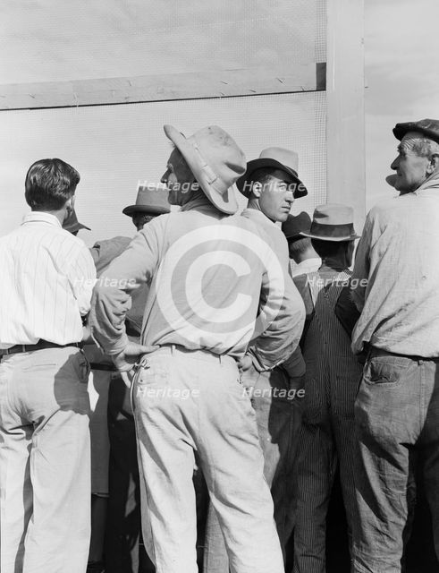 Watching ball game, Shafter migrant camp, California, 1939. Creator: Dorothea Lange.