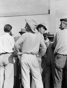 Watching ball game, Shafter migrant camp, California, 1939. Creator: Dorothea Lange