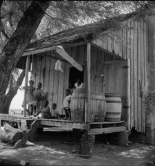 Water barrels on plantation cabin in Brazos riverbottoms, near Bryan, Texas, 1938. Creator: Dorothea Lange