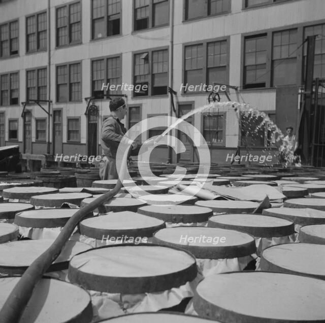 Watering fish at the Fulton fish market with brine water, New York, 1943. Creator: Gordon Parks.