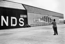 Waving the chequered flag at Brooklands, 1938 or 1939. Artist: Bill Brunell